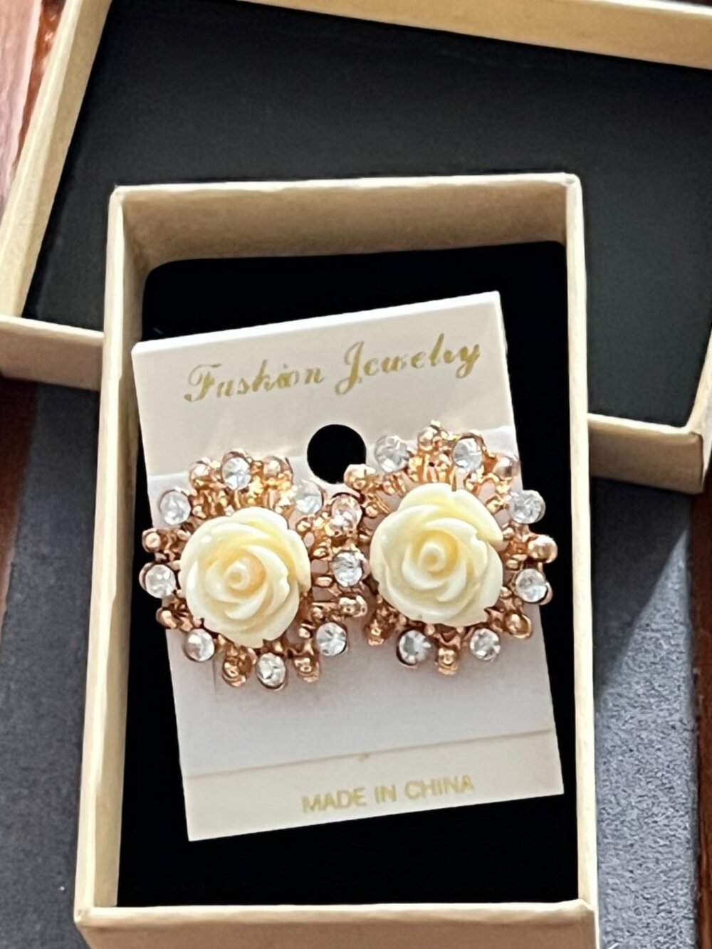 Elegant rose-gold-tone floral stud earrings featuring ivory rose centers surroun